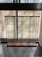 Full front view of the glass display cabinet showing its height and transparency.