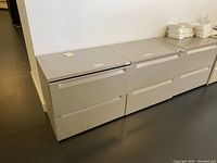 Front view of two small file cabinets side by side, to show drawer and size proportions