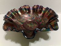 Photo of green carnival glass ruffled bowl showing inside pattern and ruffled edges with iridescent finish.