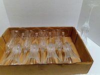 Set of six Gorham crystal champagne flutes arranged in a cardboard box, showing fluted stems and deep cut etching