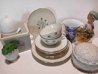 Full lot showing Lladro bell in box, Lenox dishes, tea cup with floral design, Moppet figurine, trinket dish and another figurine