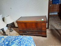 Full front and side views of the wood chest with door and drawer, showing surface details and overall structure.