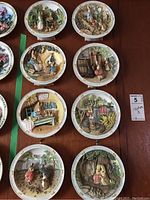 All eight Bradford Exchange Peter Rabbit collector plates arranged on a table