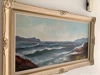 Full view of the framed acrylic seascape depicting waves and distant boat under cloudy sky.