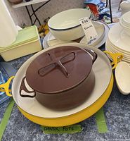 Close-up side view of yellow Dansk pot with smaller brown Dansk pot inside