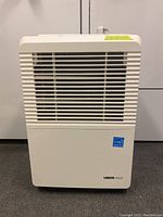 Front view of white Uberhaus dehumidifier with horizontal vents and Energy Star sticker.
