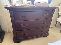 Full view of Thomasville dresser showing three drawers and carved wood detailing on sides and base.