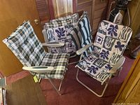 Six folding lawn chairs displayed unfolded and grouped together with cushions placed on or nearby.