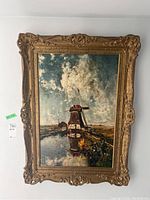 Full front view of the framed print showing windmill by the water and ornate gilded frame.
