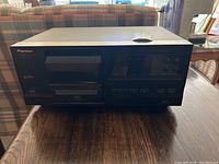 Front view of the Pioneer PD-F407 CD player showing control buttons, display, and CD tray.