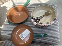 Lot overview showing two green skillets and a patterned serving bowl with spoons
