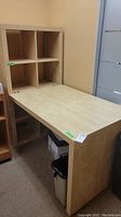 View of the light wood finish desk with attached 8-cubby storage unit showing desk surface and cubbies