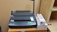 GBC Docubind P200 binding machine with plastic combs boxes, front angle