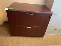 Front view of the wood file cabinet showing two drawers with silver handles