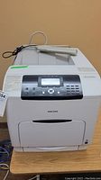 Front view of Ricoh Aficio SP C430dn printer showing control panel and screen.