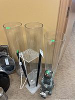 Three tall clear plexiglass vases, black lamp with clear plexiglass square base, silver decorative hare figurine