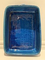 Top view showing rectangular shape, deep blue glaze, and textured tray bottom.