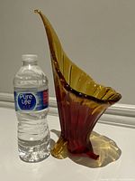 Vintage MCM Italian mouthblown glass vase with red and yellow gradient, sculptural bird-like form shown next to water bottle for scale