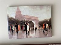 Canvas artwork showing an urban scene with an arch and pedestrians in muted colors