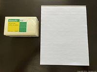 One photo shows six packs of yellow Grand & Toy self-stick Post-it Note pads stacked side by side with one letter size lined writing pad on the right, all on a dark surface.