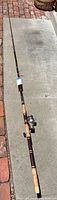 Full length view of Garcia fishing rod showing cork handle and rod blank.