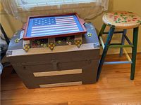 Overview of the trunk, stool, and tray showing the painted floral details and overall condition