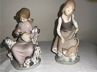 Photo showing both Lladro figurines together against a plain background.