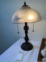 Full view of the vintage lamp showing metal base, frosted glass shade with embossed floral pattern, dual pull chains, and overall size.