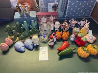 Photo showing full assortment of designer and novelty salt and pepper shakers, including boxed sets and colorful ceramic figurines.