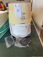 Full view of Nutrimill grain mill unit with accessories on table.