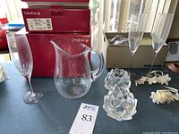 Photo showing Orrefors crystal pitcher, crystal votive candle holders, champagne glasses, and original boxes.