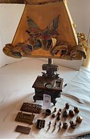Front view of assembled stove lamp with shade and displayed miniature accessories