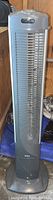 Full view of gray Seville Classics tower fan showing vertical grille and base.
