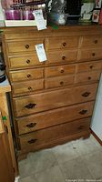Full view of the wood dresser showing upper and lower drawer sections, drawer hardware, and overall finish.