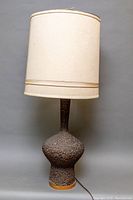 Full view of the Mid-Century Modern textured quartite table lamp with fabric drum shade, showing lamp height and overall condition.