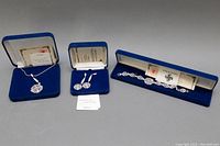 Complete set of crystal jewelry including necklace, earrings, bracelet in original blue velvet boxes with certificates of authenticity.