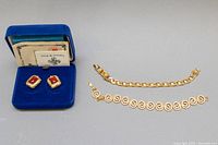 Pair of clip-on earrings, two bracelets, and original blue velvet box with paperwork