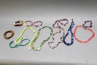 Full lot overview showing all assorted semi-precious stone jewelry items including necklaces and bracelets in various colors and types.