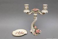 Full view of the Alka Kunst Dresden porcelain floral candleholder next to the Zsolnay porcelain ashtray, showing overall lot contents.