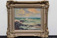Front view of the framed oil painting showing the seascape and ornate frame.
