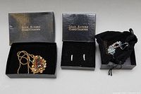 Full set showing three jewelry items in their boxes: gold-tone pendant necklace with large amber stone, pair of blue rhinestone earrings, and multi-gemstone necklace pouch.