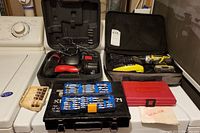 Full lot showing drills, drill bits, and keying kits on white surface
