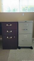 BBF brown metal filing cabinet with three drawers next to Anderson Hickey beige filing cabinet on castors