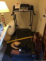 Full treadmill view with items around it for size reference.