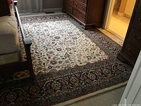 Full view of rug laid out between bed and dresser in bedroom
