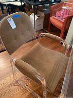 Front angle of a single chair showing seat cushion, backrest and clear acrylic frame