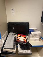 Overview of briefcase, shirts, underwear, accessory box, and jewelry on shelf