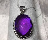 Close-up front view of faceted amethyst quartz pendant showing deep purple color and 925 silver bezel.