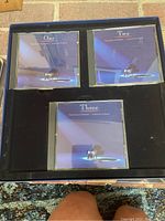 Three CDs labeled One, Two and Three from The Music of Disney laid out in presentation box