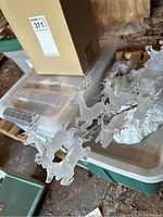 Glass reindeer and Santa sleigh holiday decor on white snowy base